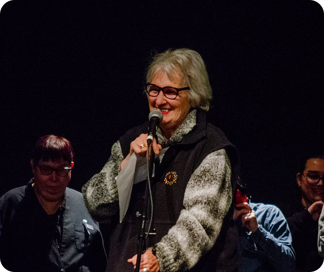 A woman giving her speech happily
