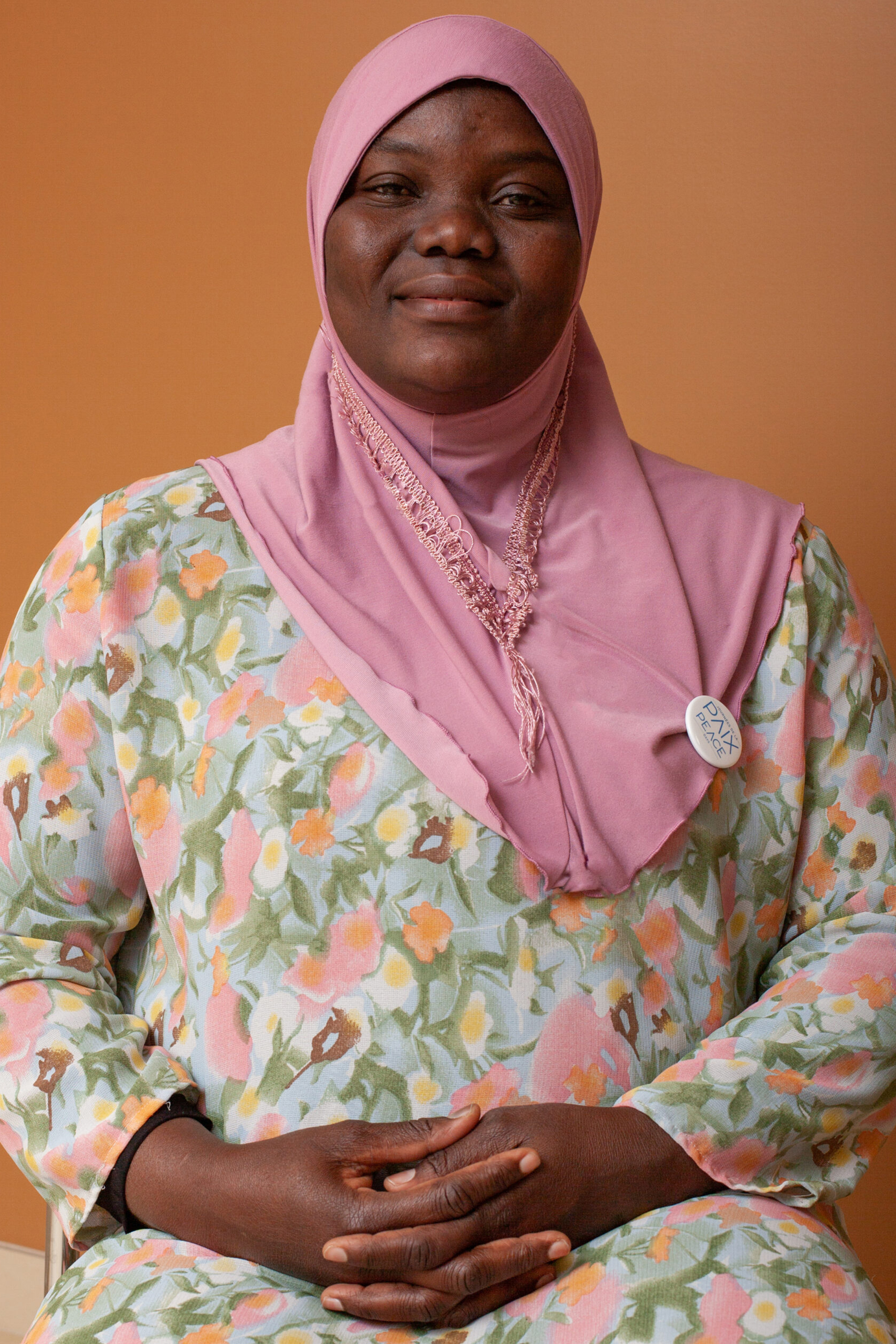 a black woman sitting with a bandana on it's head